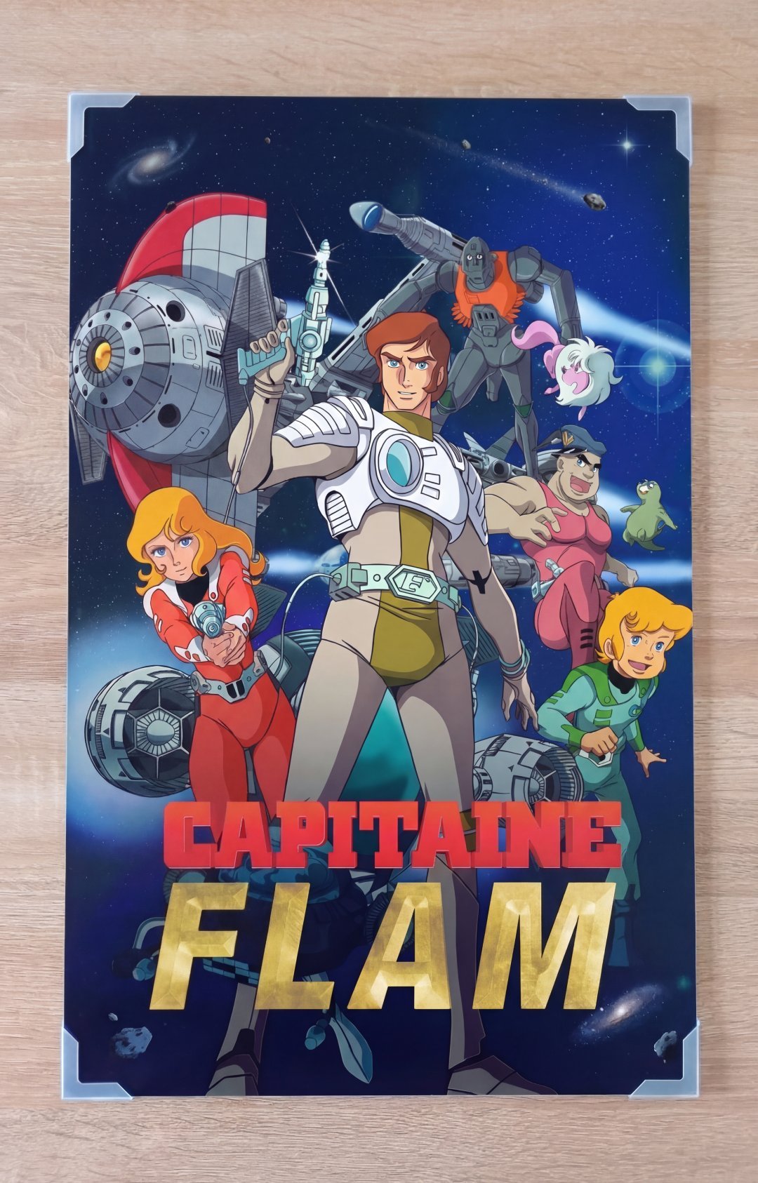 Plaque en aluminium Dibond 3mm Capitaine Flam posée sur un établi en bois, montrant les couleurs vibrantes et la netteté de l'impression UV - Fabrication artisanale française.
